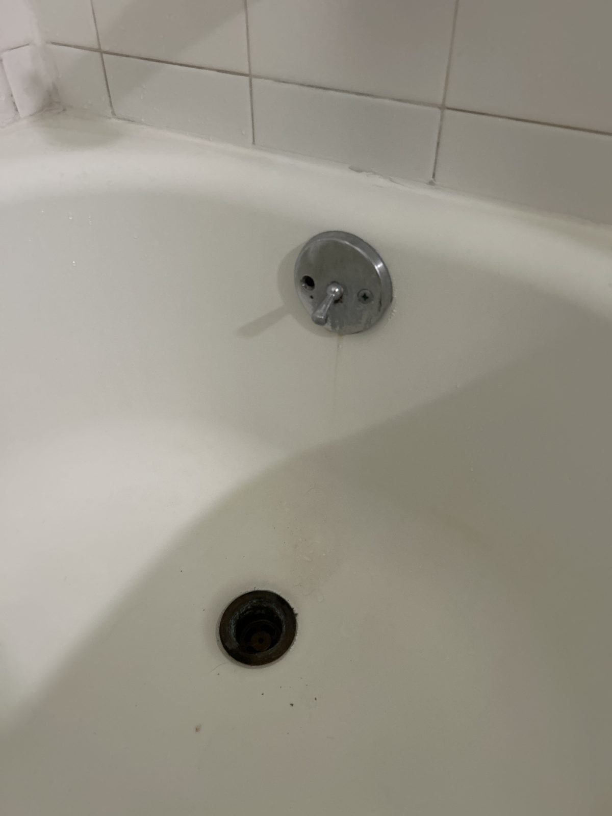 Corroded bathtub waste and overflow before replacement