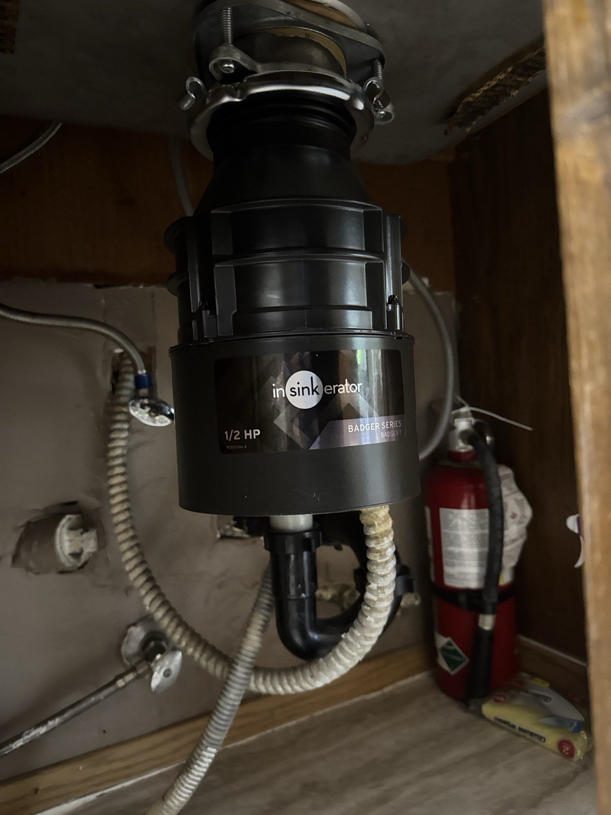 InSinkErator Badger garbage disposal replacement under a kitchen sink in Newberg, Oregon by True Flow Plumbing PDX